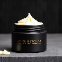 Matte black jar of natural hair styling clay with a subtle texture.